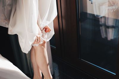 Woman looking through window