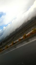 View of road against cloudy sky