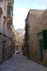 Street amidst buildings in city against sky