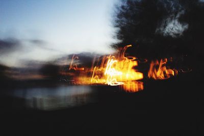 Close-up of wet fire against sky at night