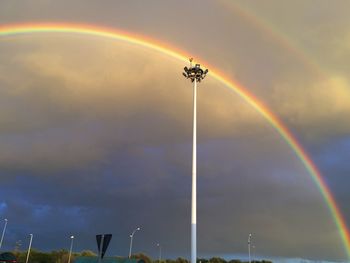 Low angle view of rainbow against sky during sunset