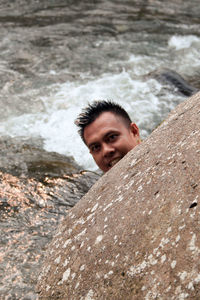 High angle portrait of man on rock