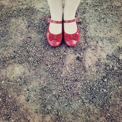 Low section of woman standing on tiled floor