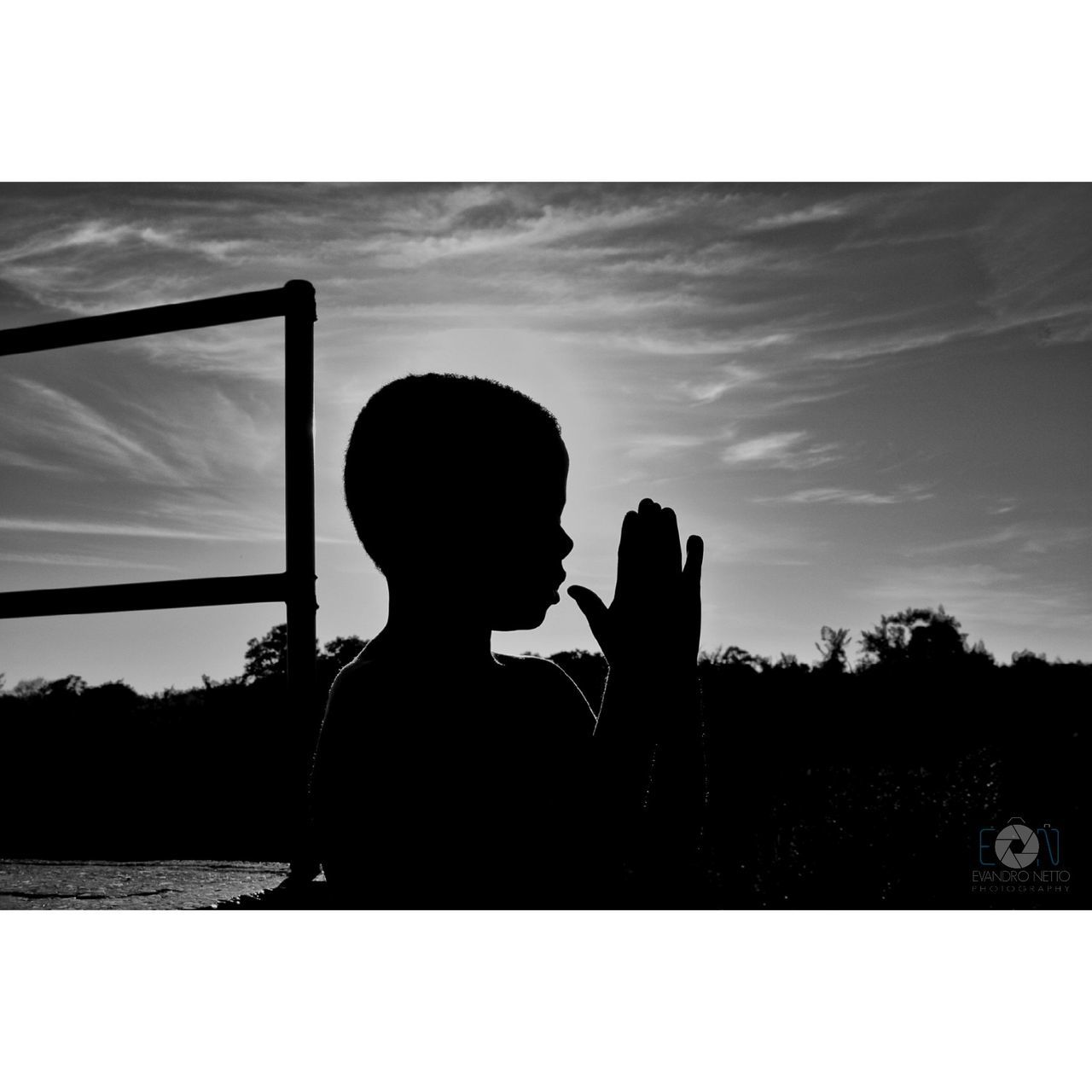 SILHOUETTE BOY PHOTOGRAPHING AGAINST SKY