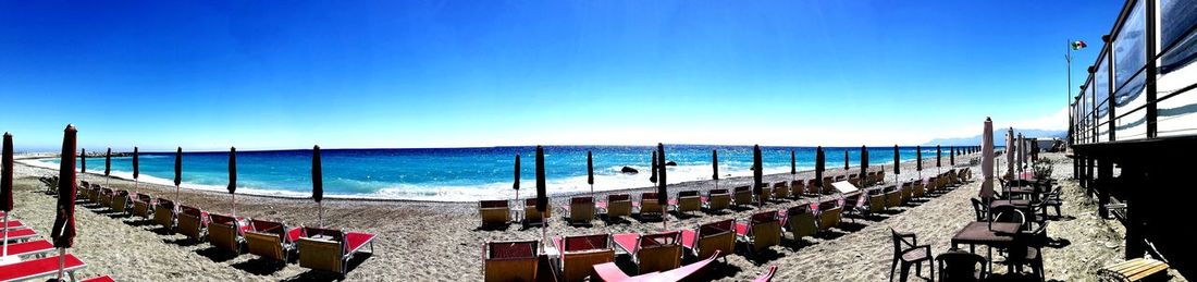 Panoramic view of beach against blue sky