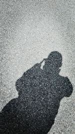 Low section of person shadow on road