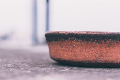 Close-up of earthenware bowl on footpath