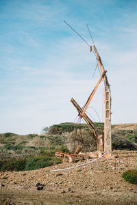 Windmill on landscape against sky