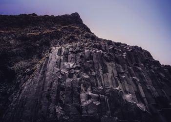 Low angle view of tree mountain against sky