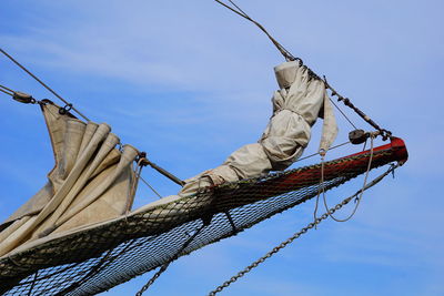 Low angle view of mast against blue sky