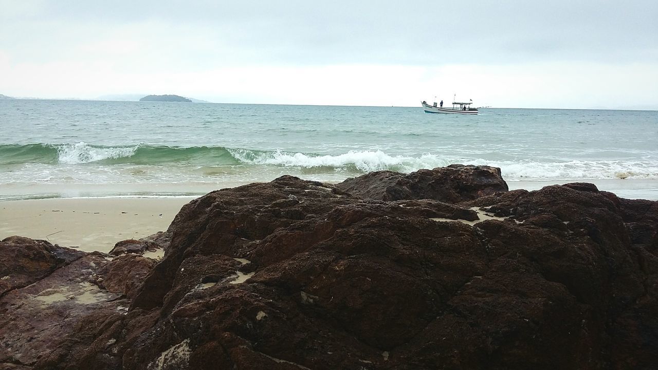 sea, horizon over water, water, beach, scenics, sky, tranquil scene, tranquility, beauty in nature, shore, rock - object, wave, nature, idyllic, surf, remote, rock formation, coastline, outdoors, day