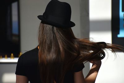 Rear view of woman wearing hat outdoors