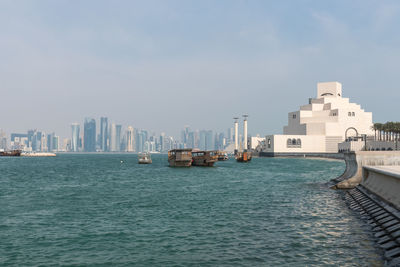 View of sea and cityscape against sky