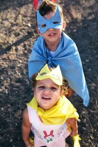 Children disguised as superheroes to play in the field, are watching o