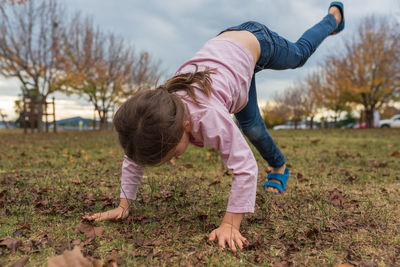 Full length of girl playing on field