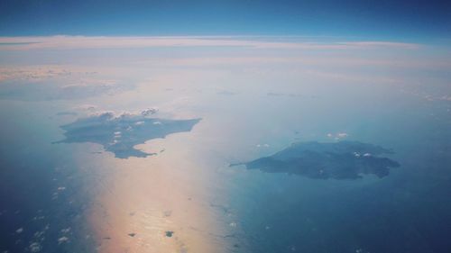 Aerial view of sea against blue sky