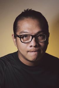 Close-up portrait of mature man against colored background