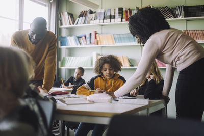 Teachers teaching students in classroom at school