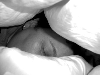 Close-up of woman sleeping on bed