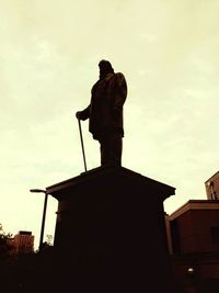 Low angle view of statue against sky