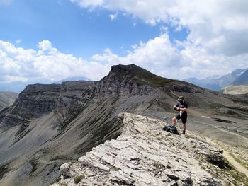 Full length of man on rocks against sky