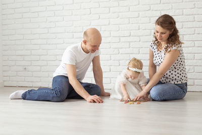 Parents playing with deaf daughter at home