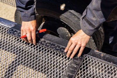 High angle view of man working on metal