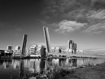 Low angle view of skyscrapers against cloudy sky