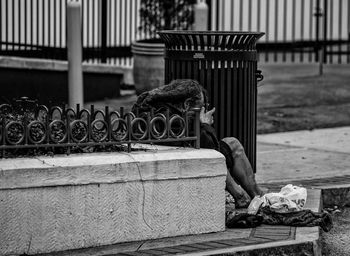 Beggar sitting on sidewalk