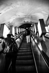 Low angle view of people on escalator