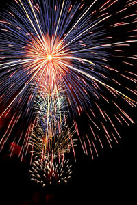 Low angle view of firework display at night