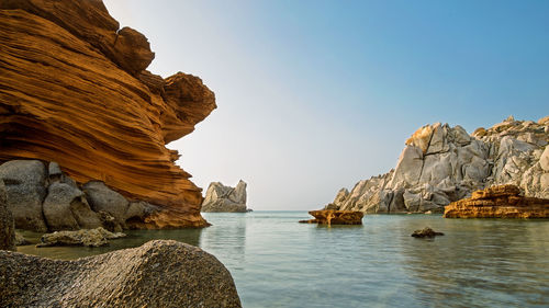 Scenic view of rock formations and sea against sky