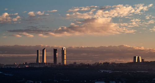 Smoke emitting from factory against sky