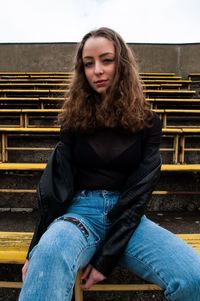 Portrait of teenage girl sitting on bench