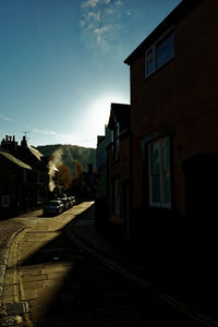 Street amidst buildings against sky in city