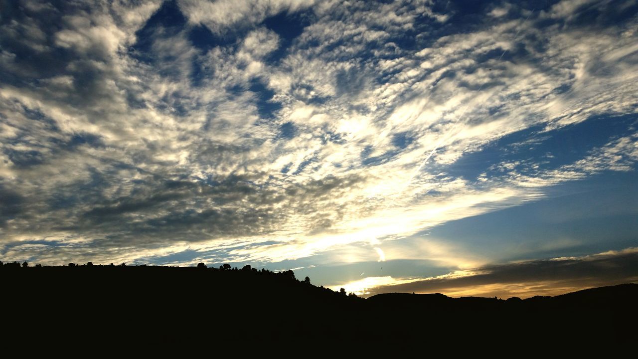 silhouette, sunset, sky, scenics, tranquil scene, beauty in nature, tranquility, cloud - sky, landscape, nature, cloud, idyllic, cloudy, low angle view, dark, outline, outdoors, dramatic sky, sunlight, no people