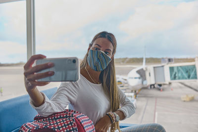 Young woman waiting to board the plane in the lounge the simon bolivar