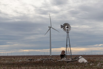 Windmill on field against sky