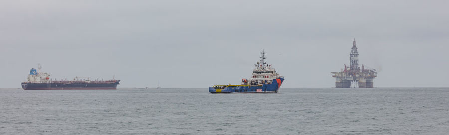 Ship sailing on sea against sky