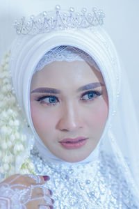 Close-up portrait of young woman in warm clothing