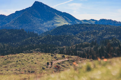 Scenic view of field and mountains against sky