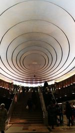 People in illuminated shopping mall