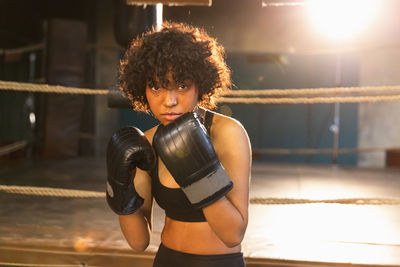 Portrait of young woman exercising in gym