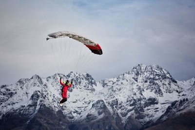 Person paragliding in sky