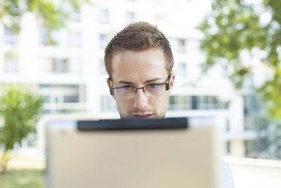 Portrait of young man using mobile phone