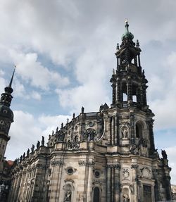 Low angle view of historic building against cloudy sky