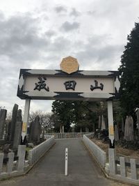 View of text on road against cloudy sky