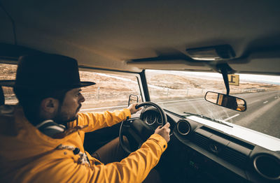 Portrait of young man in car