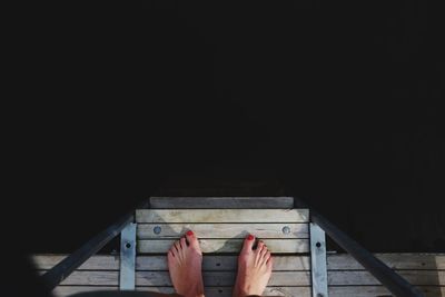 Low section of woman standing on staircase