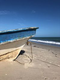 Scenic view of beach against blue sky